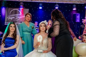 Wedding reception venue with theatrical lighting and guests mingling on the dance floor.