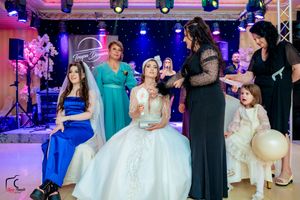 Wedding venue decorated with modern lighting featuring a mix of purple and blue hues.