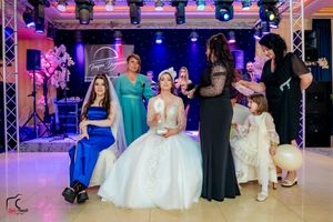 Reception venue with dramatic lighting design and guests gathered for celebration.