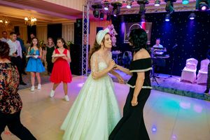 Wedding reception venue with blue and purple lighting effects creating a festive atmosphere.