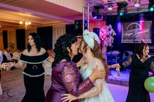 Wedding party celebration with dramatic lighting and dance floor setup in an elegant ballroom.
