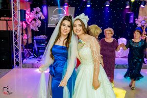Wedding party dancing and celebrating in a beautifully decorated venue with starlit backdrop.