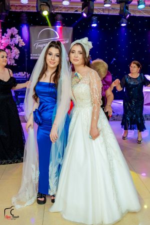 Wedding reception featuring guests in formal attire with stunning purple and blue ambient lighting.