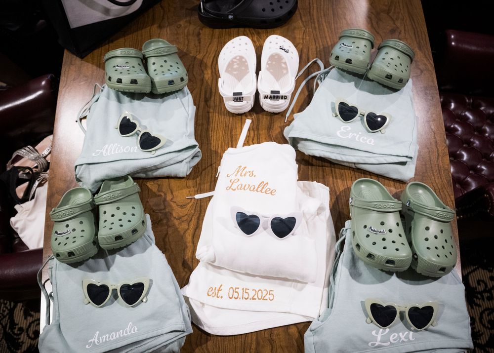 Custom wedding party favor bags and matching mint green Crocs slippers decorated with sunglasses designs.