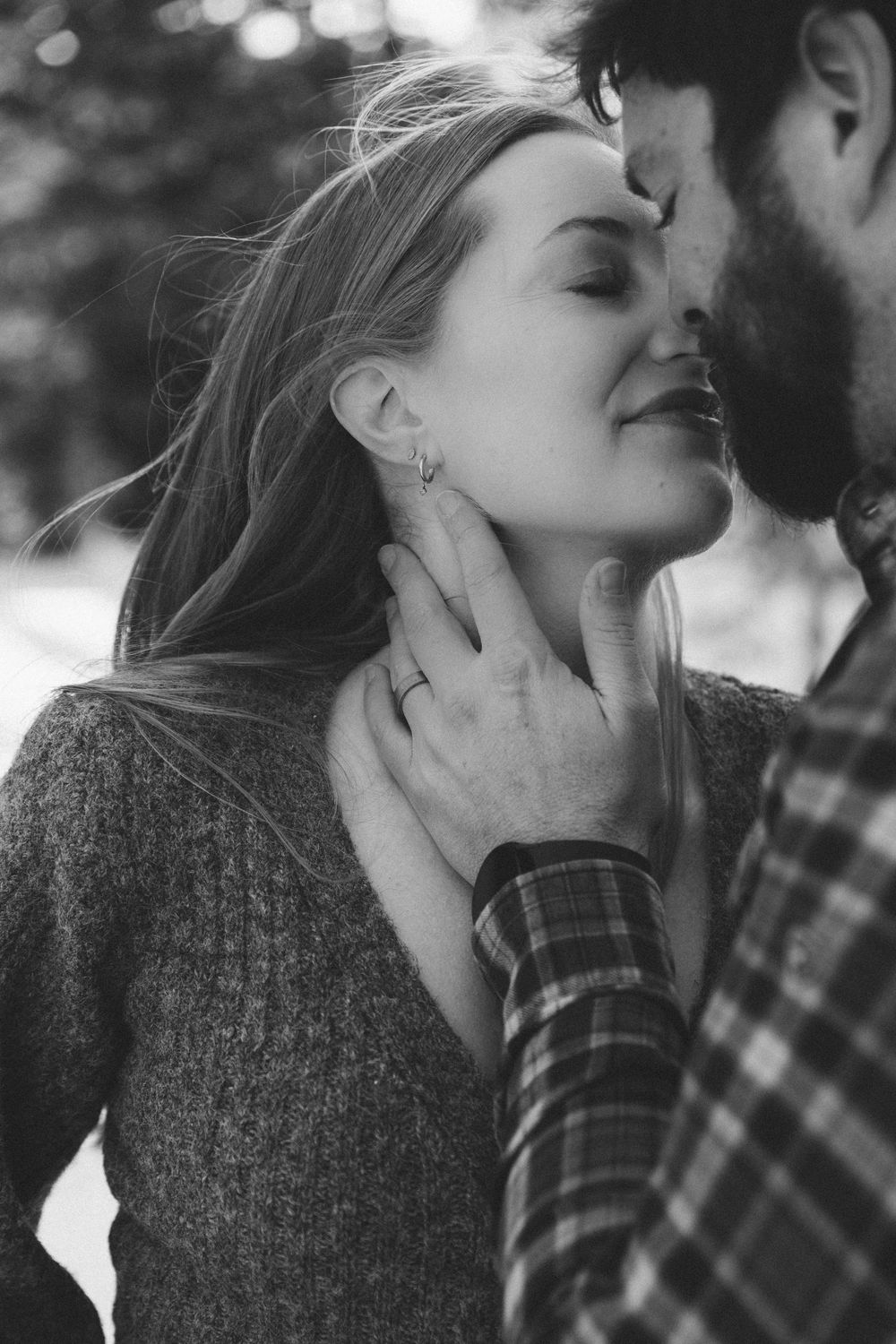 Black and white romantic sequence of intimate moments between couple with one wearing a plaid shirt.