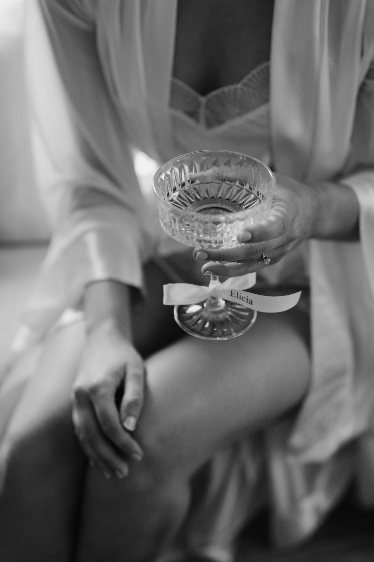 Champagne glass being held by brides hand in the cottage at Iscoyd park