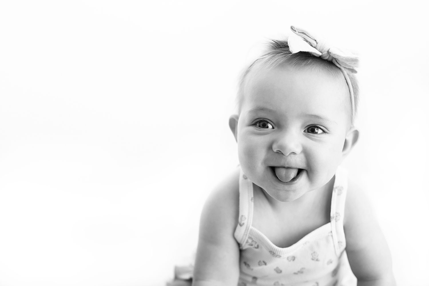 Black and white profile portrait showing pure joy and laughter with head tilted back.