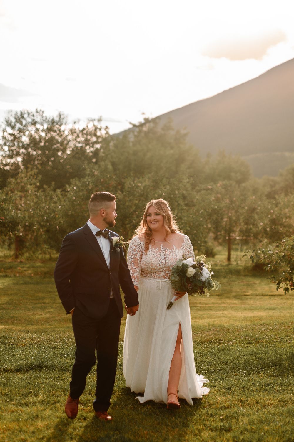 Bride and groom on their wedding day in a field in Ontario, captured during golden hour by a professional wedding photographer