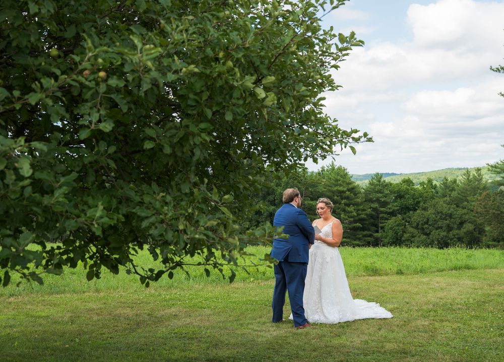 Outdoor wedding ceremony photos showing a couple posing among lush green trees and landscaping.