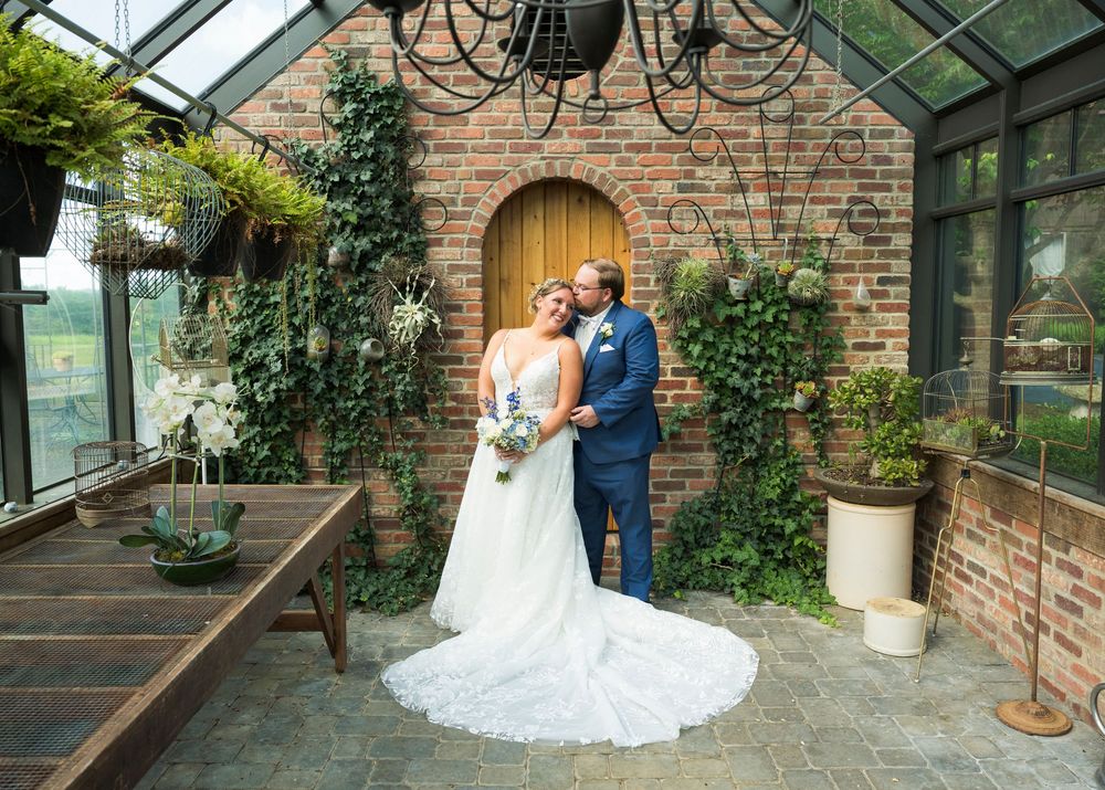 Wedding venue interior with exposed brick walls and elegant glass ceiling.