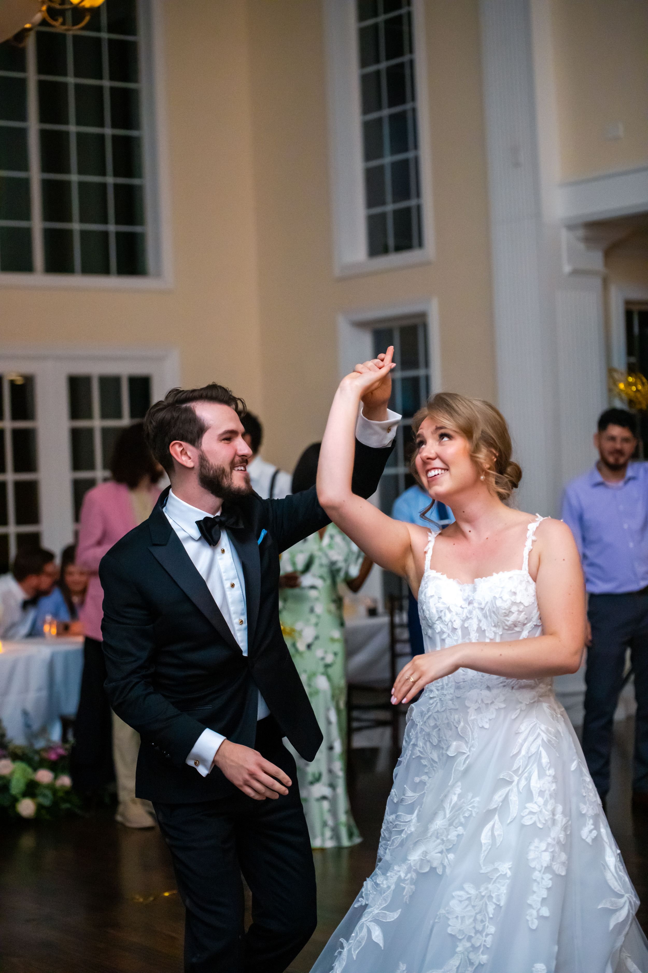 Couple dancing and laughing together during their wedding reception.