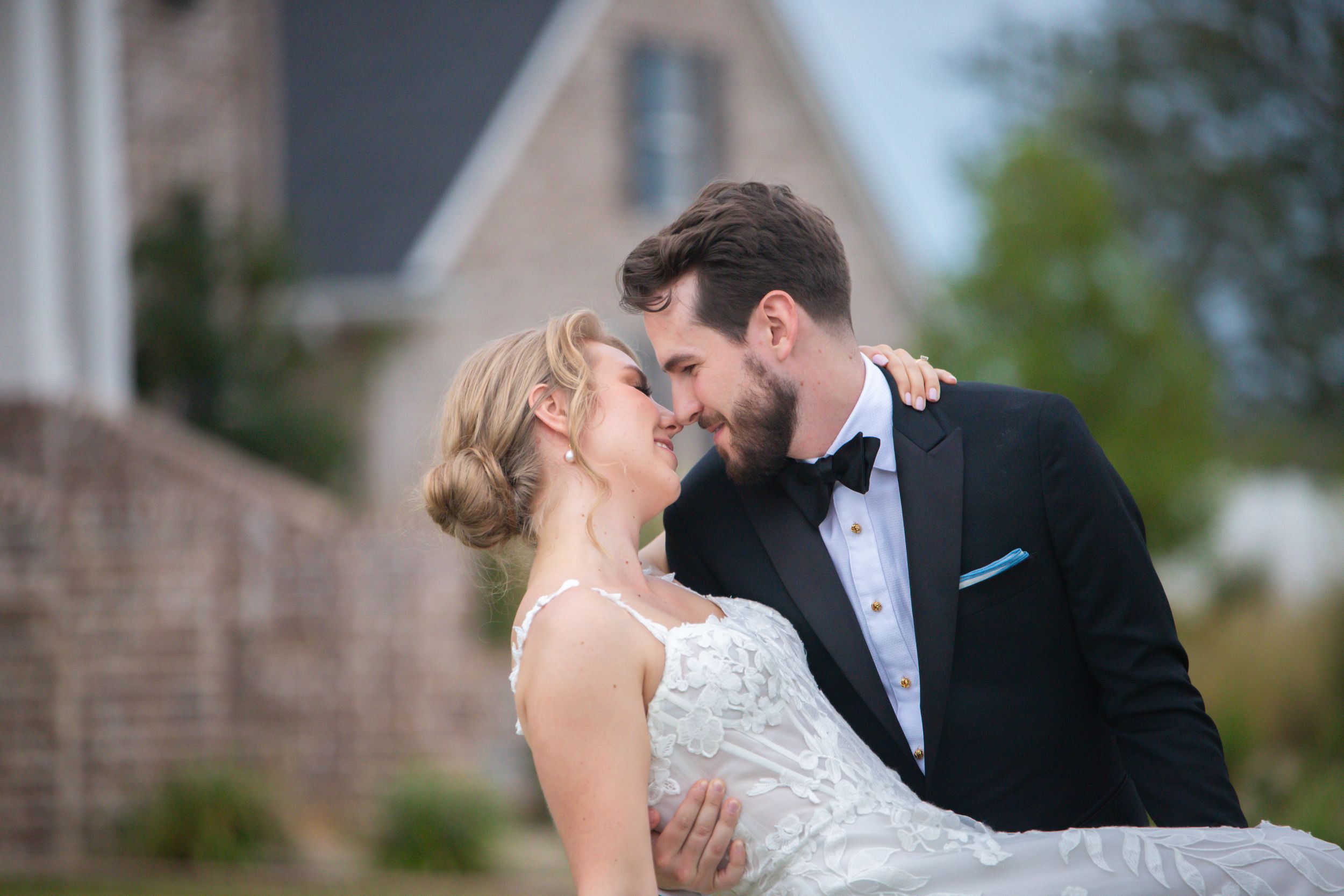 Romantic outdoor wedding portrait with soft evening lighting.