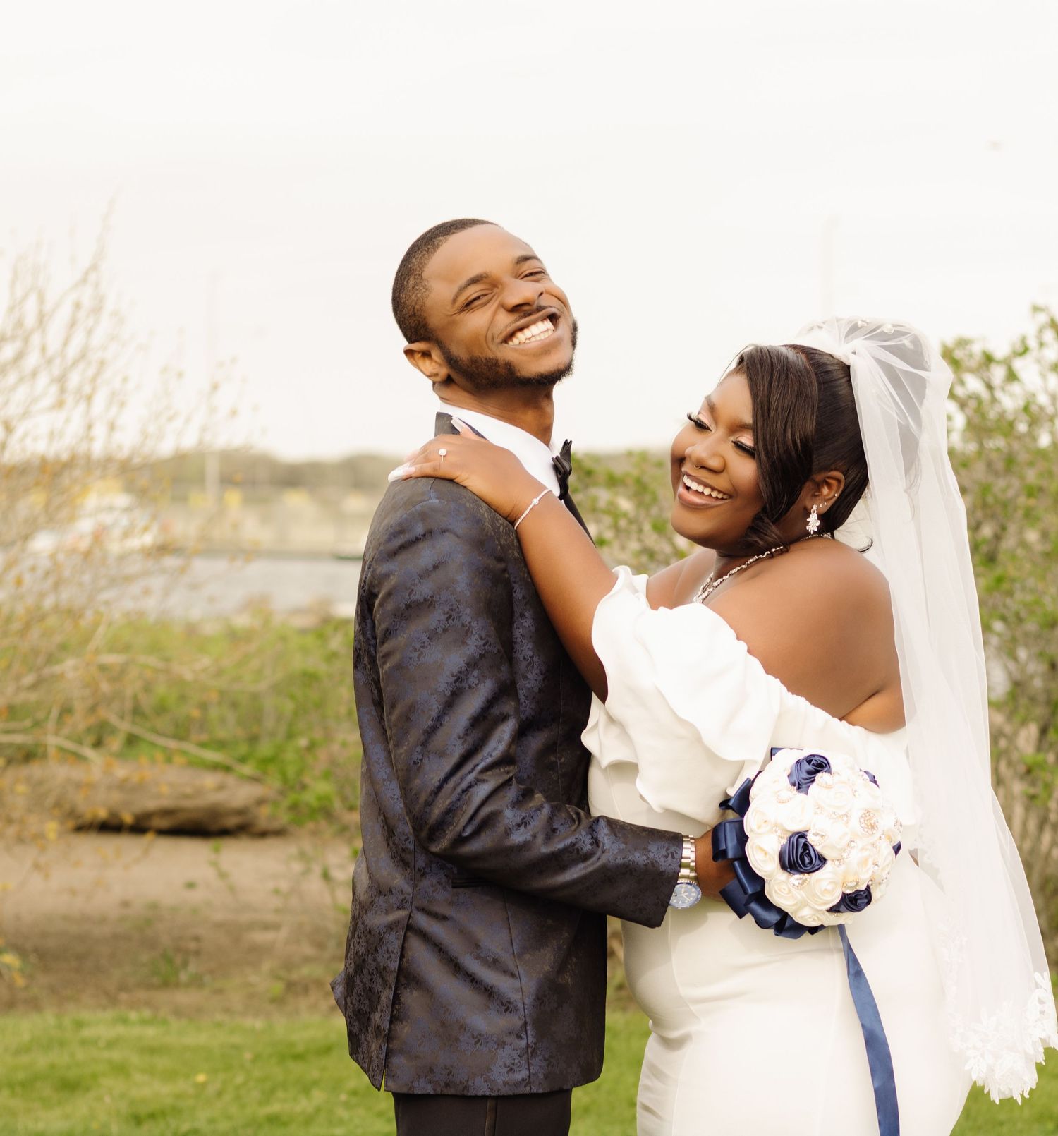 A happy couple shares a tender moment during their outdoor wedding photoshoot.