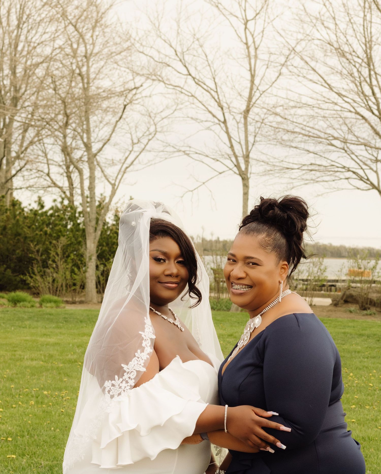 Two people share a warm moment together during outdoor wedding festivities on a spring day.