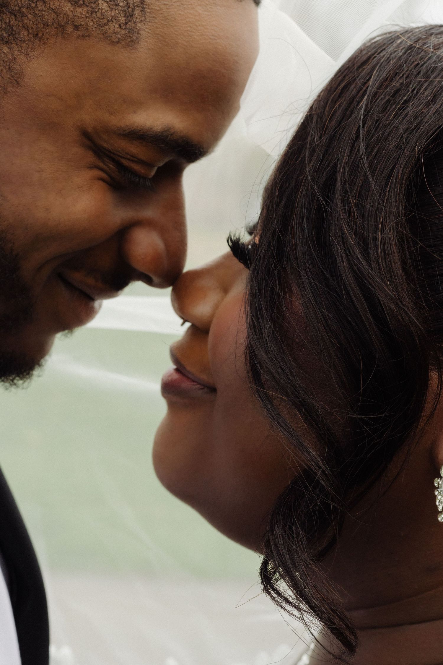 A romantic close-up moment between newlyweds sharing an intimate gaze.