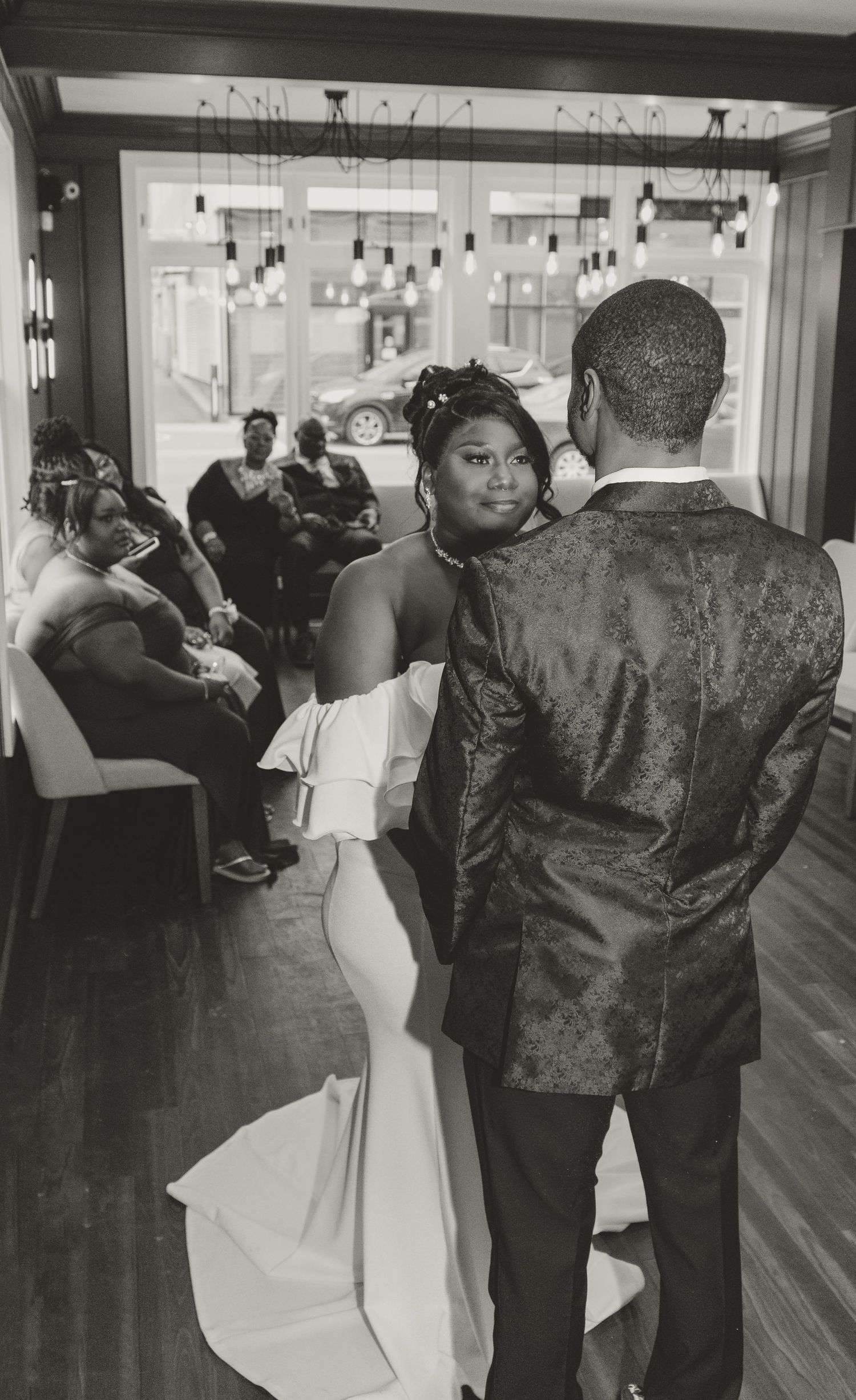 A couple shares an intimate moment on the dance floor at their wedding reception.