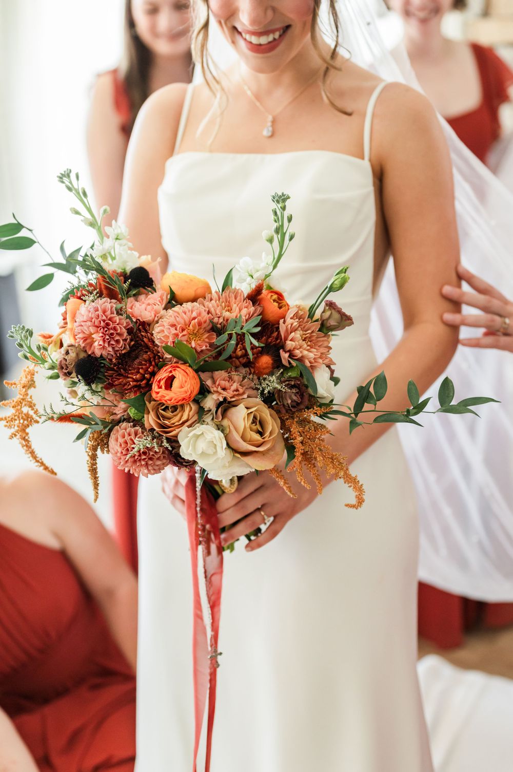 Bridal holds colorful fall bouquet at her wedding at OSU's St. John Catholic Student Center in Stillwater, Oklahoma.