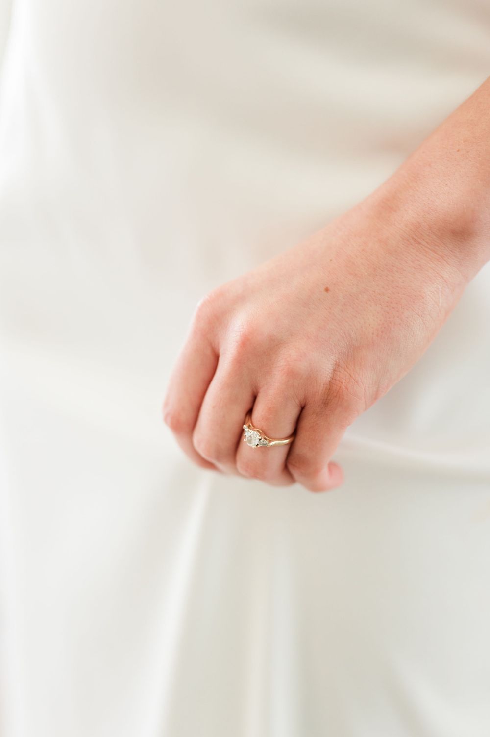 Bride holds her dress as she gets ready to get married at wedding at OSU's St. John Catholic Student Center in Stillwater, Oklahoma.