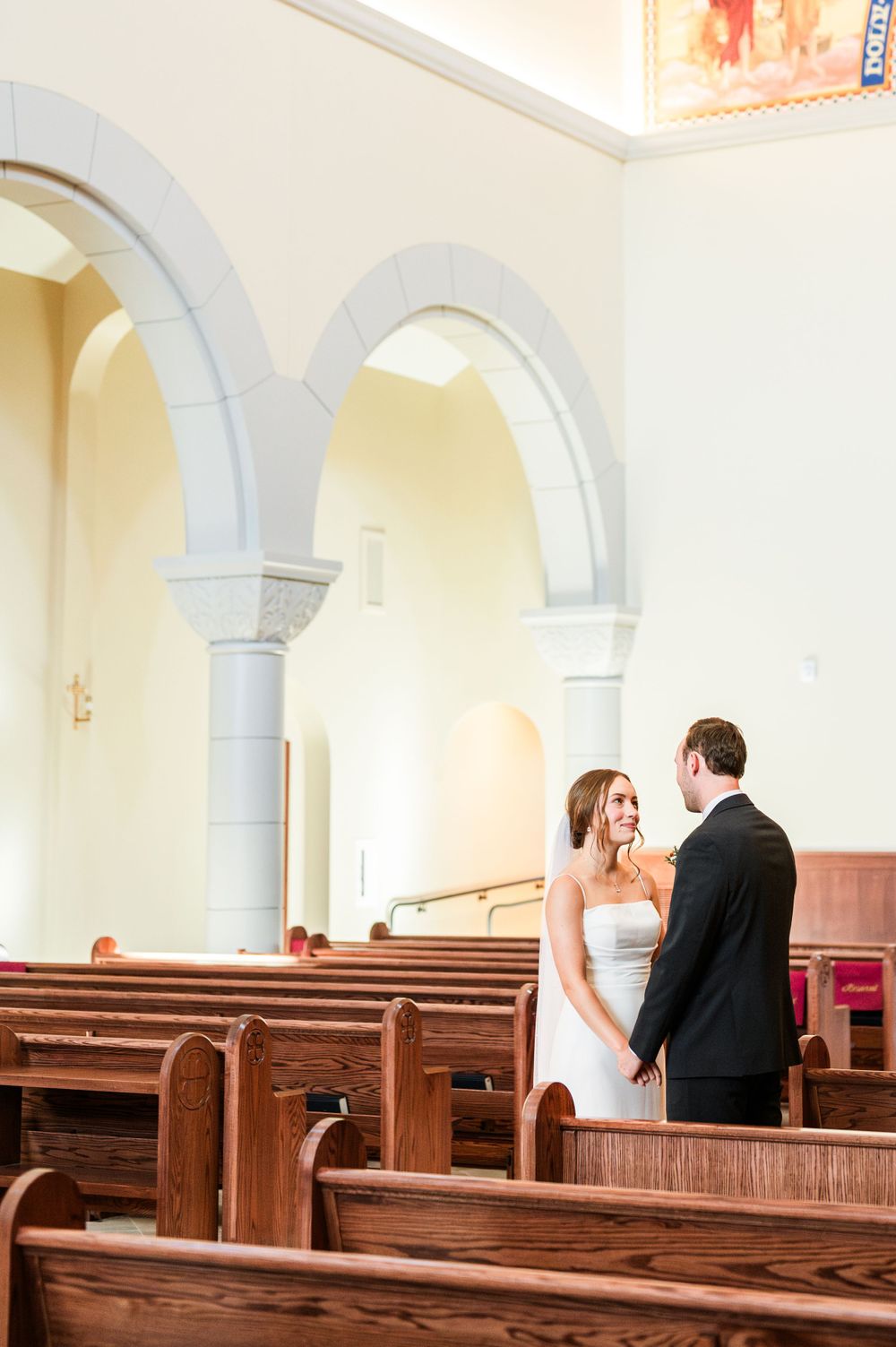 Bride and groom share a first look at their wedding at OSU's St. John Catholic Student Center in Stillwater, Oklahoma.