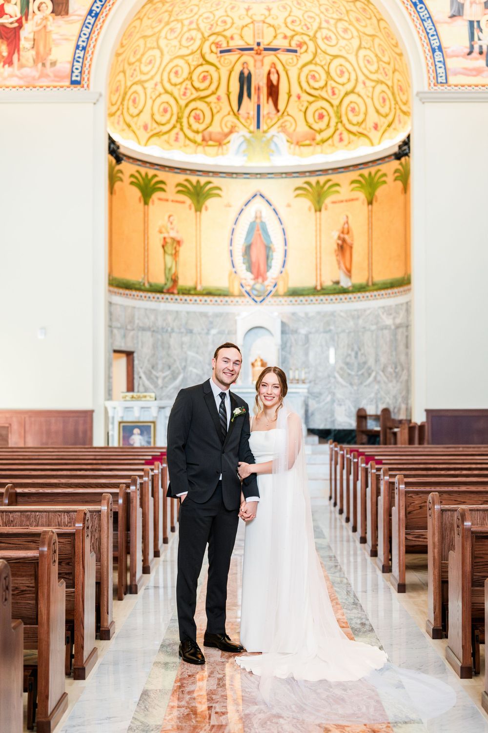 Bride and groom share a first look at their wedding at OSU's St. John Catholic Student Center in Stillwater, Oklahoma.