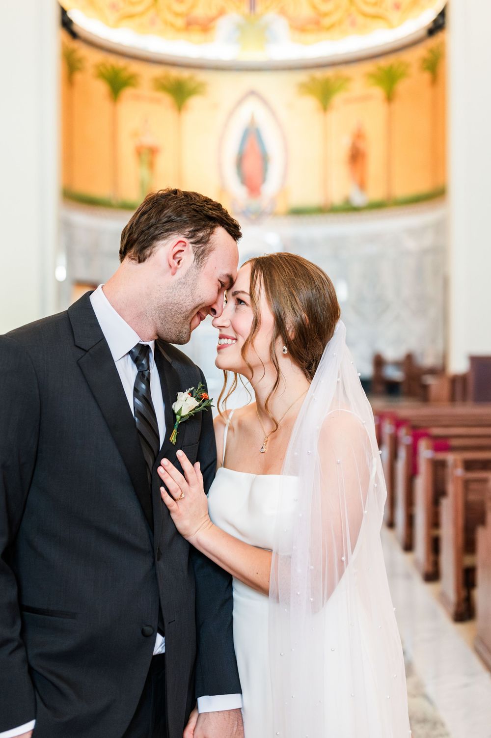 Bride and groom share a first look at their wedding at OSU's St. John Catholic Student Center in Stillwater, Oklahoma.
