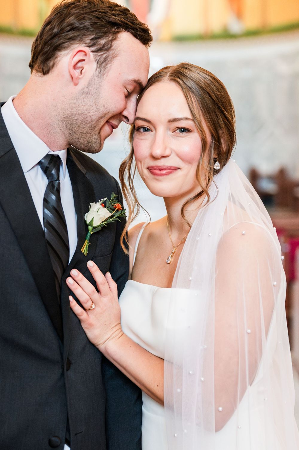 Bride and groom share a first look at their wedding at OSU's St. John Catholic Student Center in Stillwater, Oklahoma.