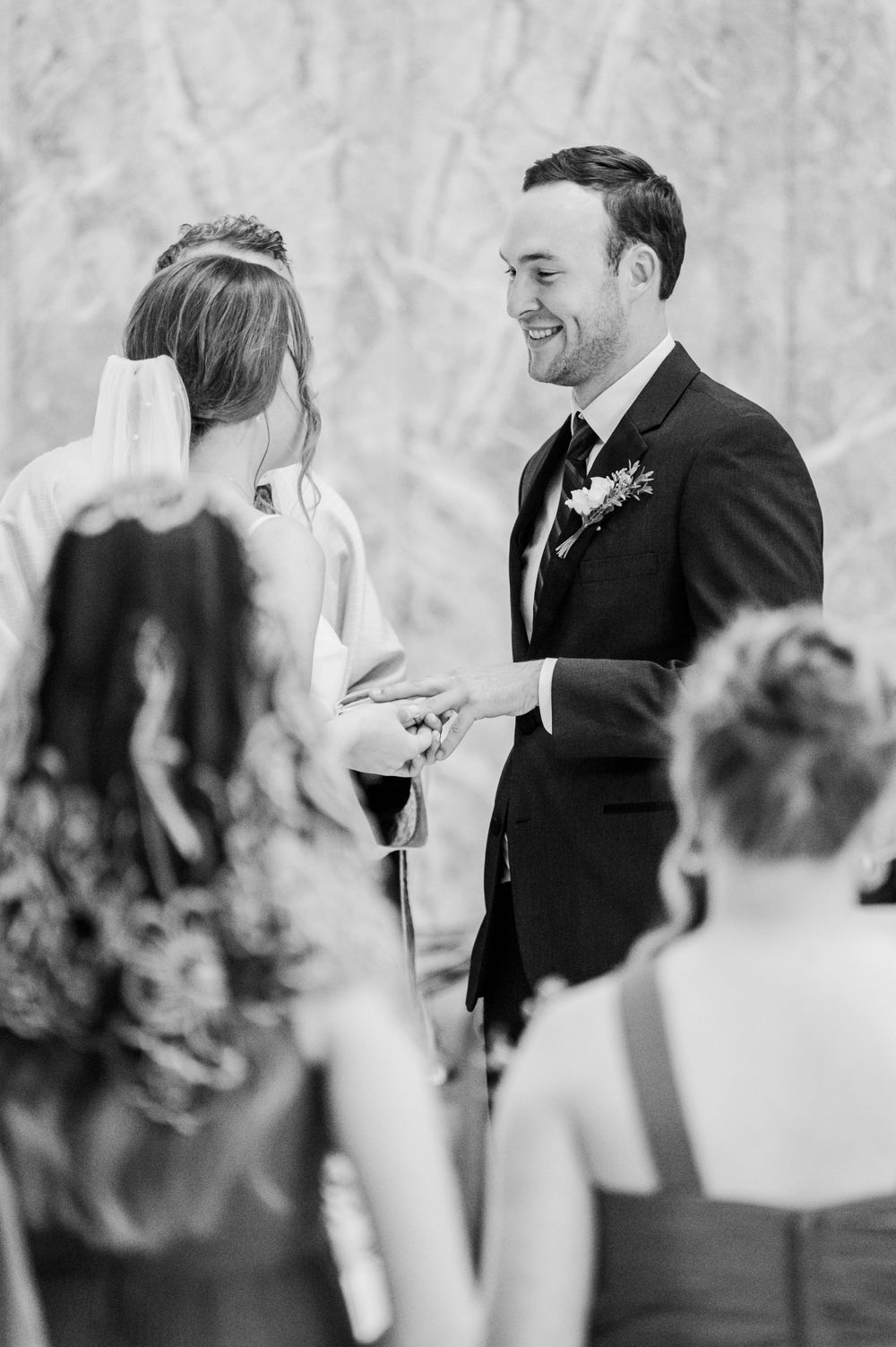 Bride slips ring on groom during Nuptial Mass at OSU's St. John Catholic Student Center in Stillwater, Oklahoma.