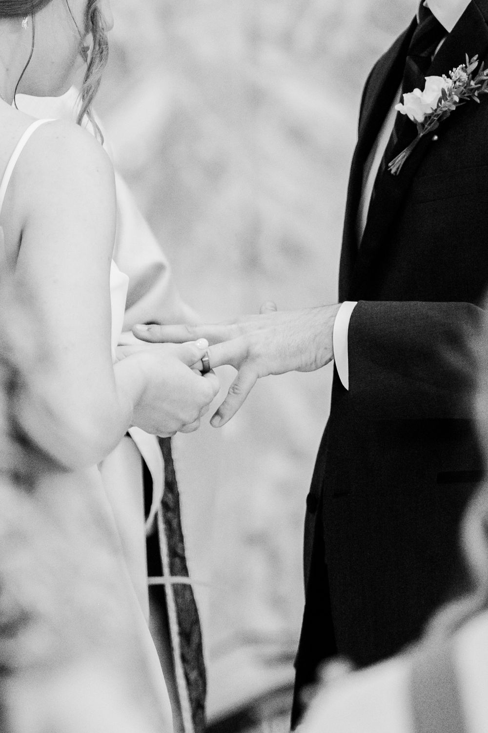 Bride slips ring on groom during Nuptial Mass at OSU's St. John Catholic Student Center in Stillwater, Oklahoma.