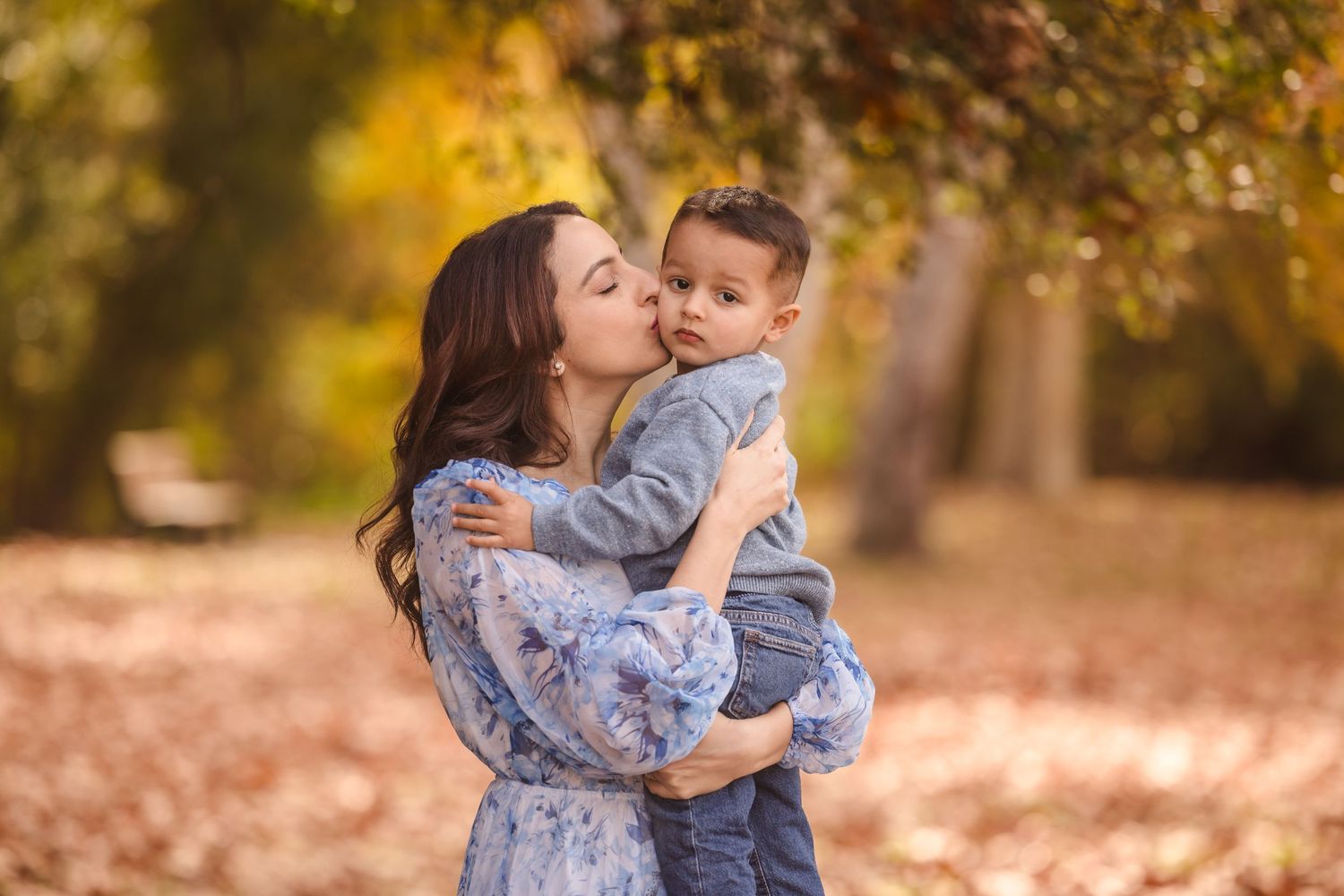 A tender moment between parent and child during an autumn photoshoot.