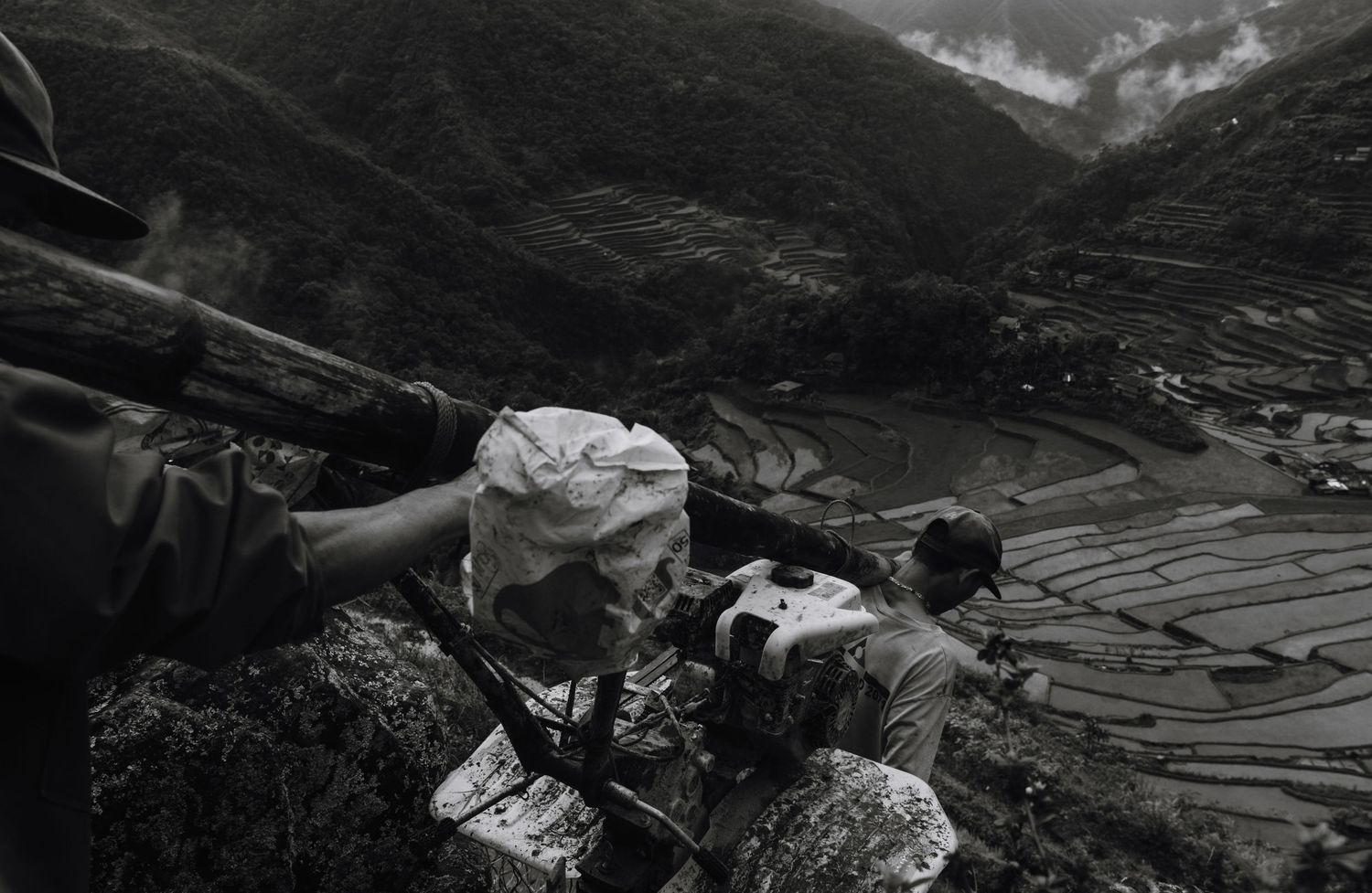 Black and white panorama of terraced rice fields in mountainous terrain.