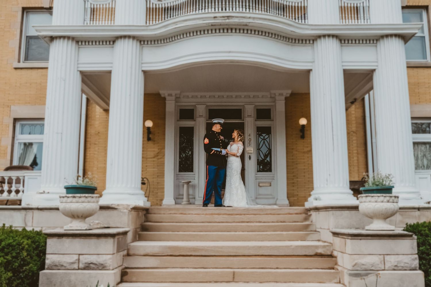 Wedding ceremony at elegant venue with classic white columns.