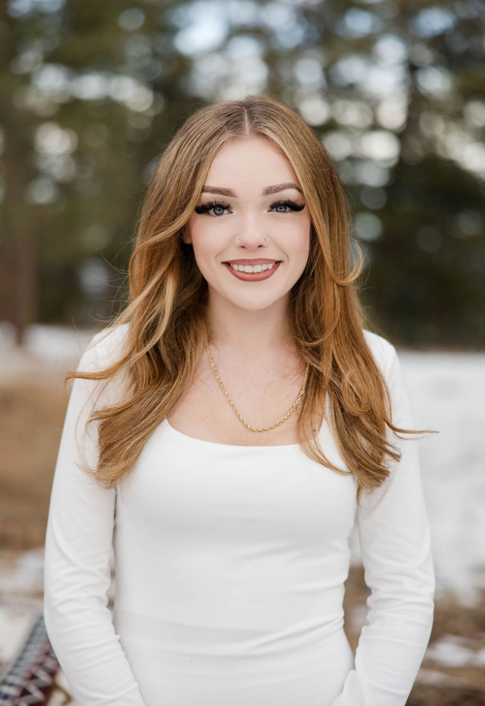 Gia poses casually for her senior pictures at Mount Falcon in Morrison, CO.