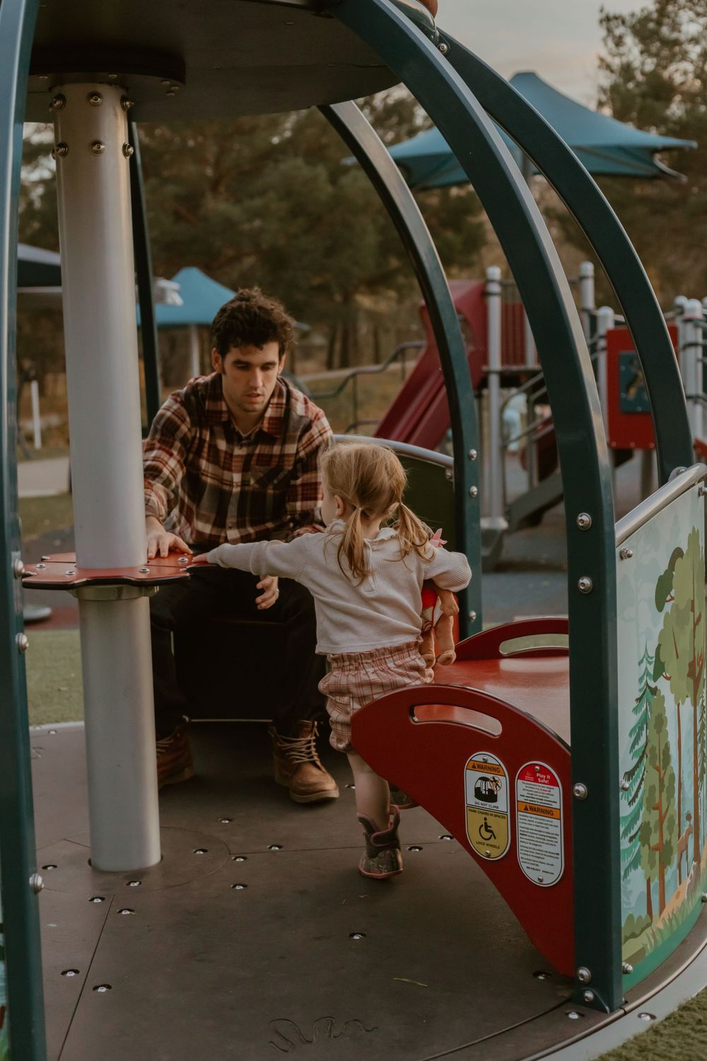A playful scene at a children's playground structure with warm sunset lighting.