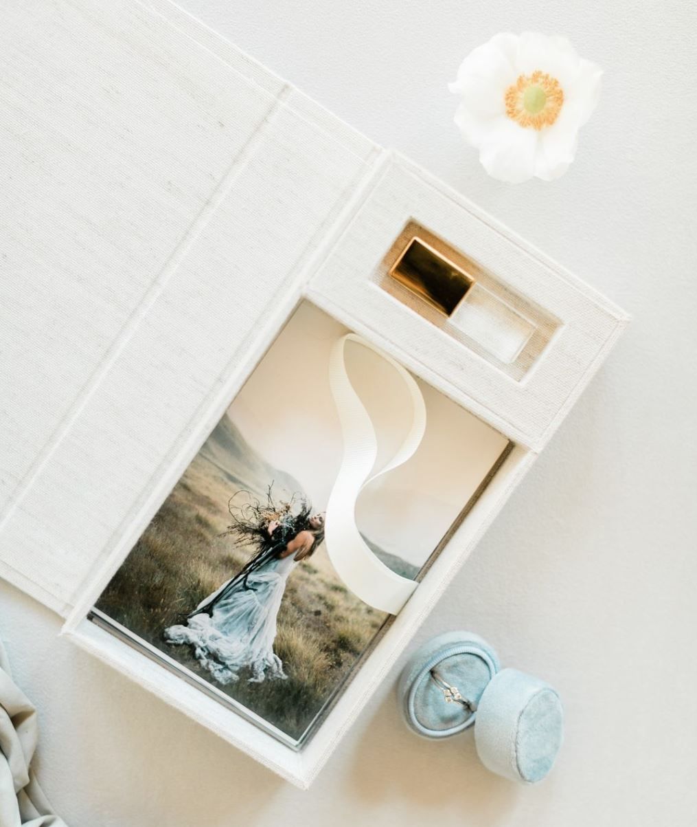 A romantic wedding photo displayed on a wall above bathroom accessories including toiletries and soap dish.