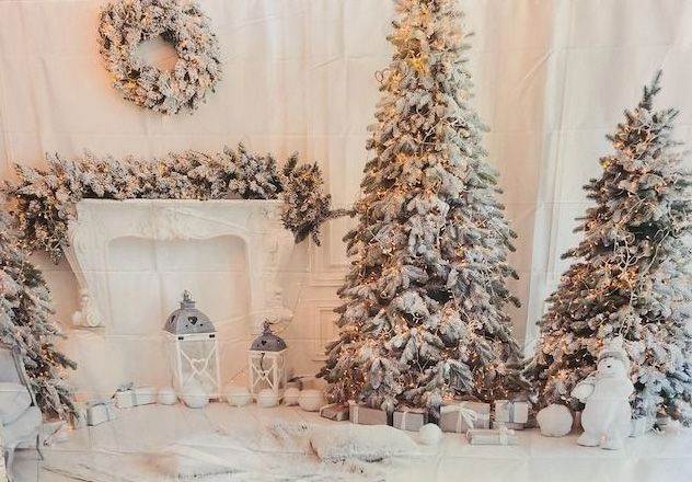 Winter wonderland scene with snow-covered Christmas trees and decorative lanterns around a white fireplace.