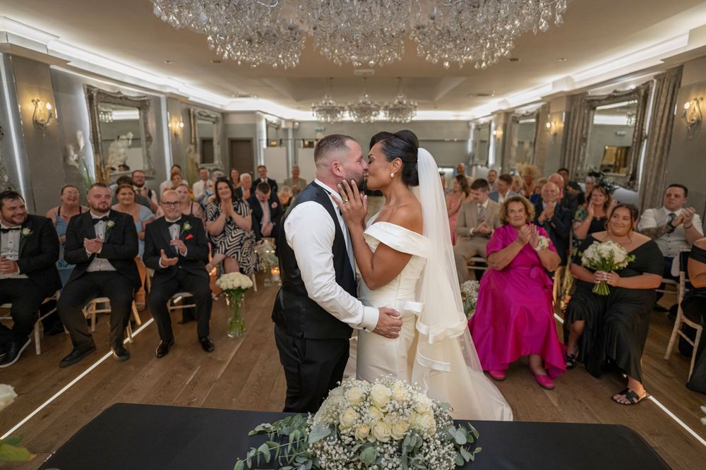 Elegant ballroom with crystal chandeliers and wedding reception setup.