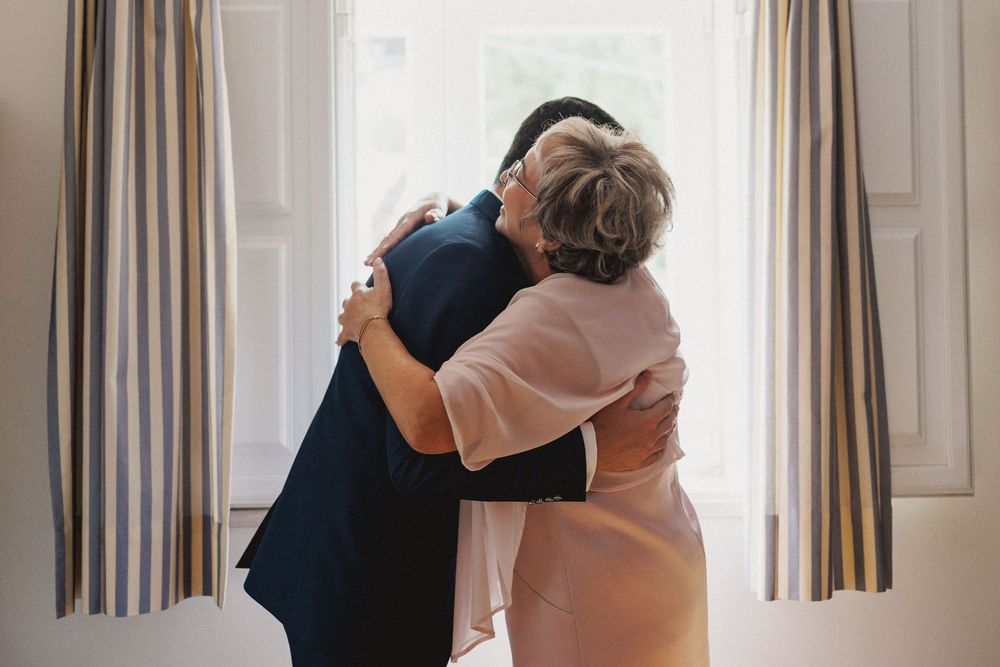 mother and groom emotional hug during grooms preparations