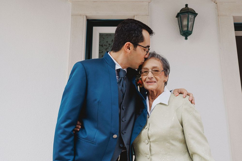 groom and grandmother share a warm embrace during a wedding celebration.