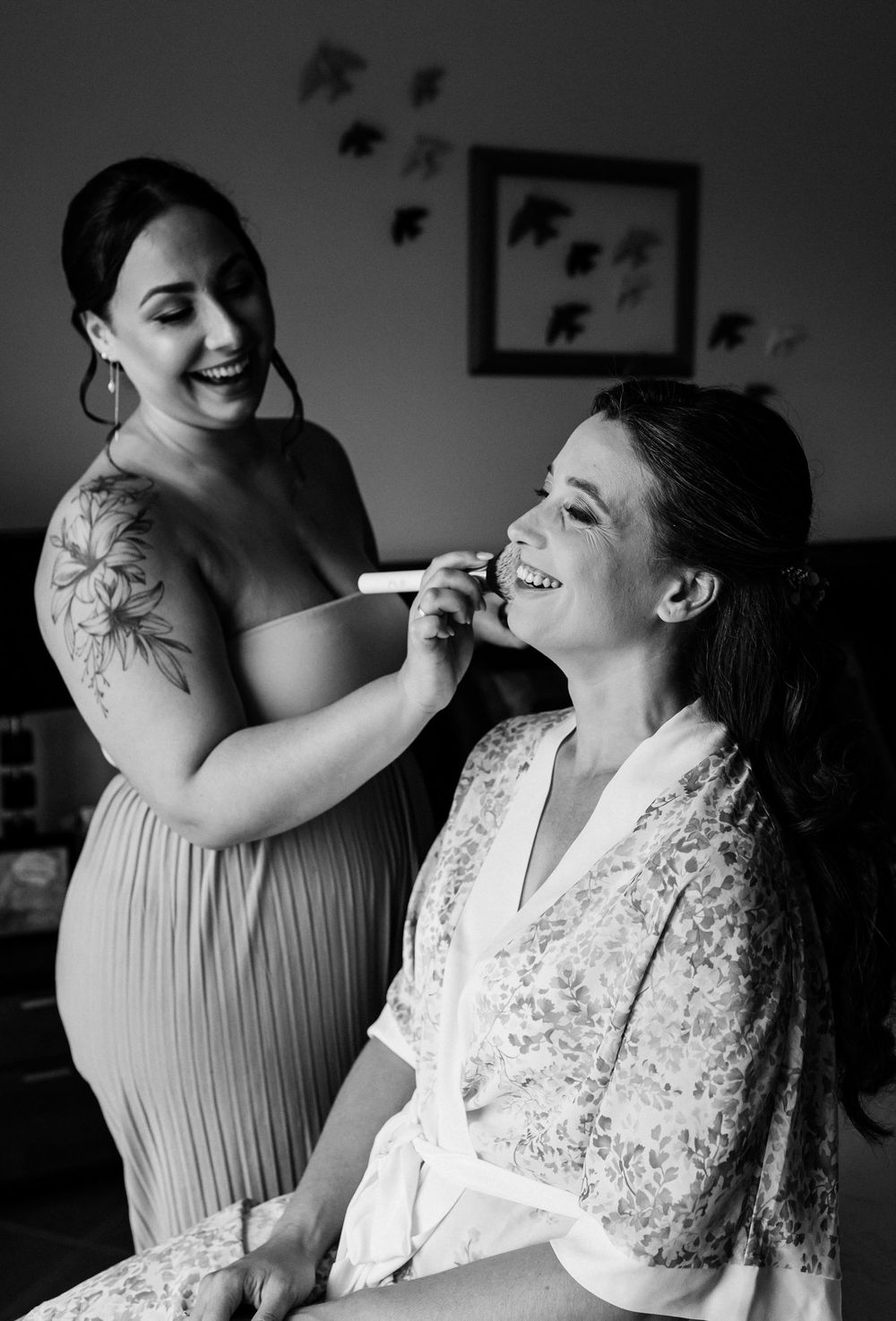 bride getting ready at parents home surrounded by sisters and mother