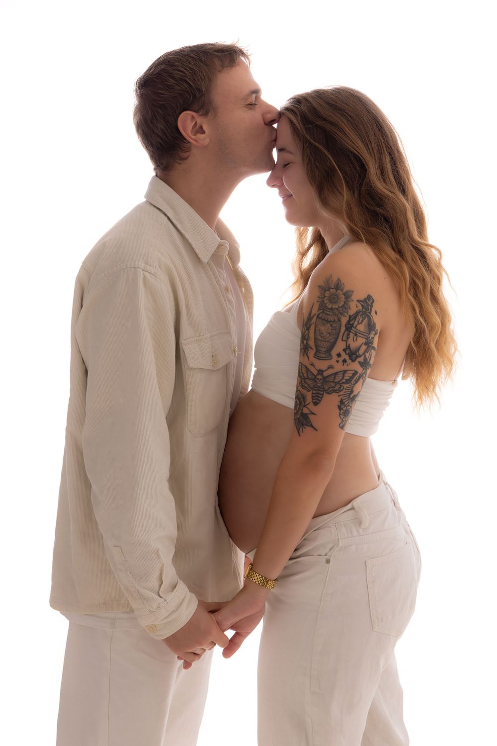 A romantic sequence of three poses showing a couple in white embracing against a light background.