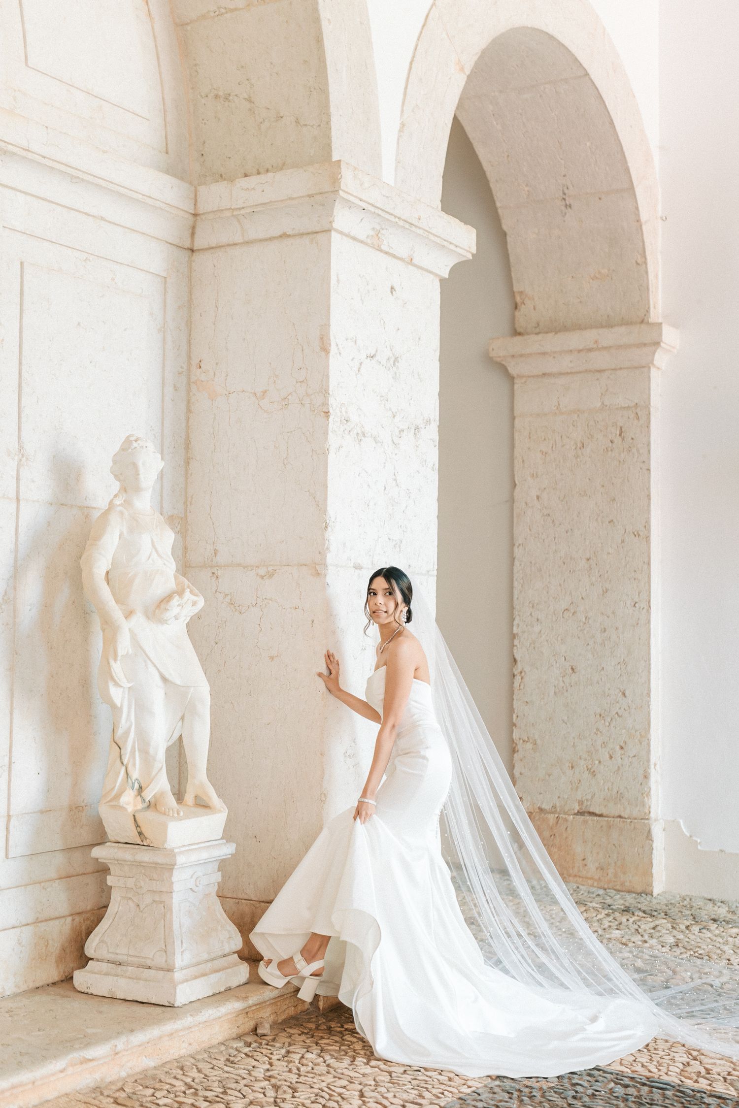 Indian bride in white wedding dress portrait at Palácio do Correio-Mor Portugal