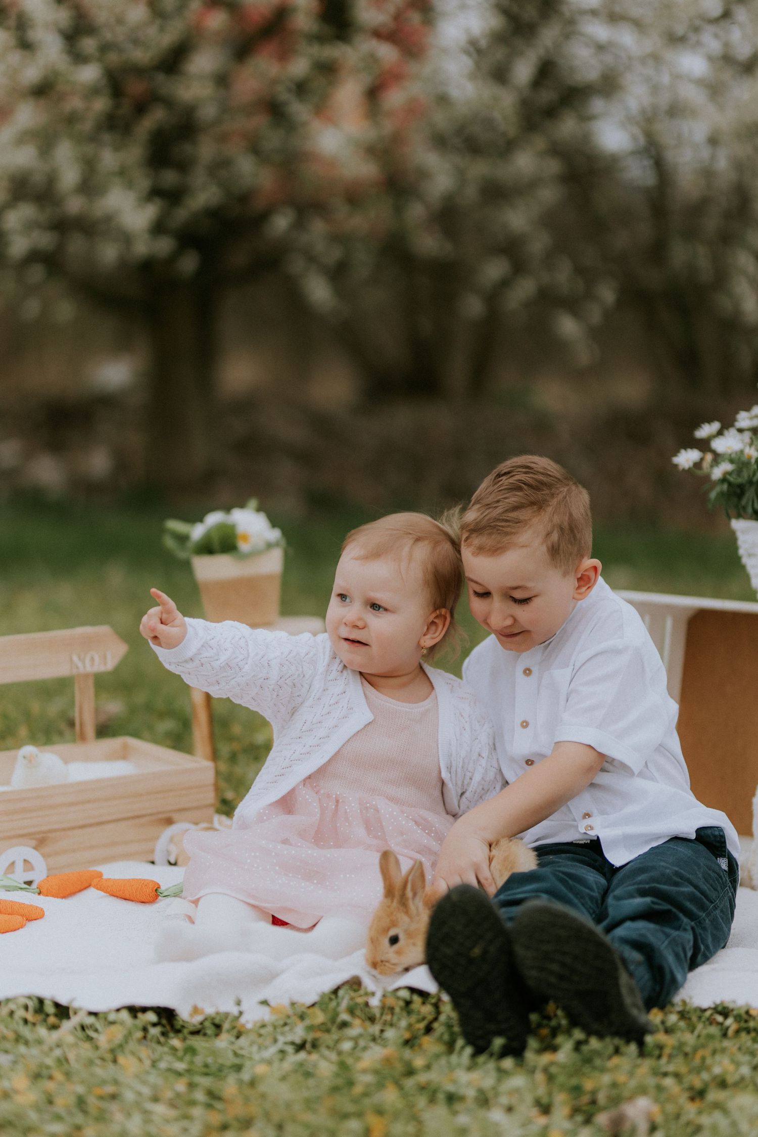 Brat a sestra v objatí počas jarného fotenia v prírode so živým zajačikom. Autentické rodinné momentky, okres Žilina.
