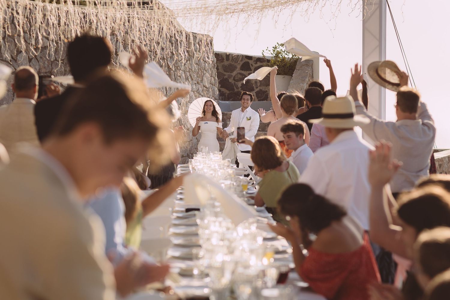 Santorini wedding guests welcome the bride and groom down the stairs at El Viento.