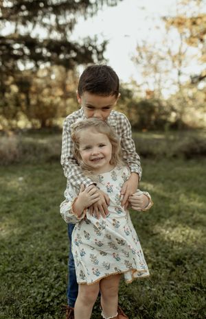 A playful outdoor family moment captured in a series of candid shots during golden hour in a grassy field.