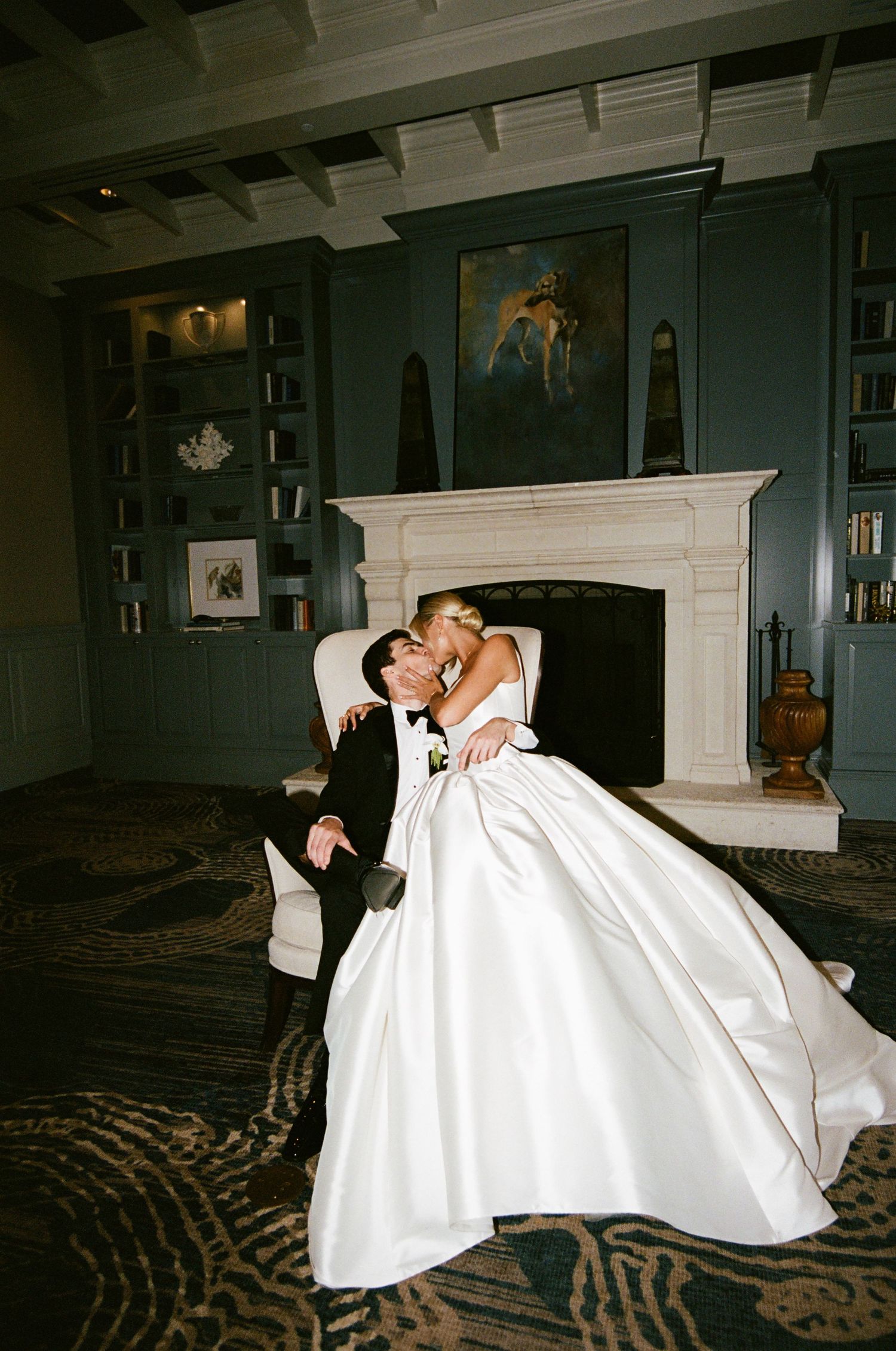 A romantic sequence of dance moves between a couple in formal wedding attire against a dark interior setting.