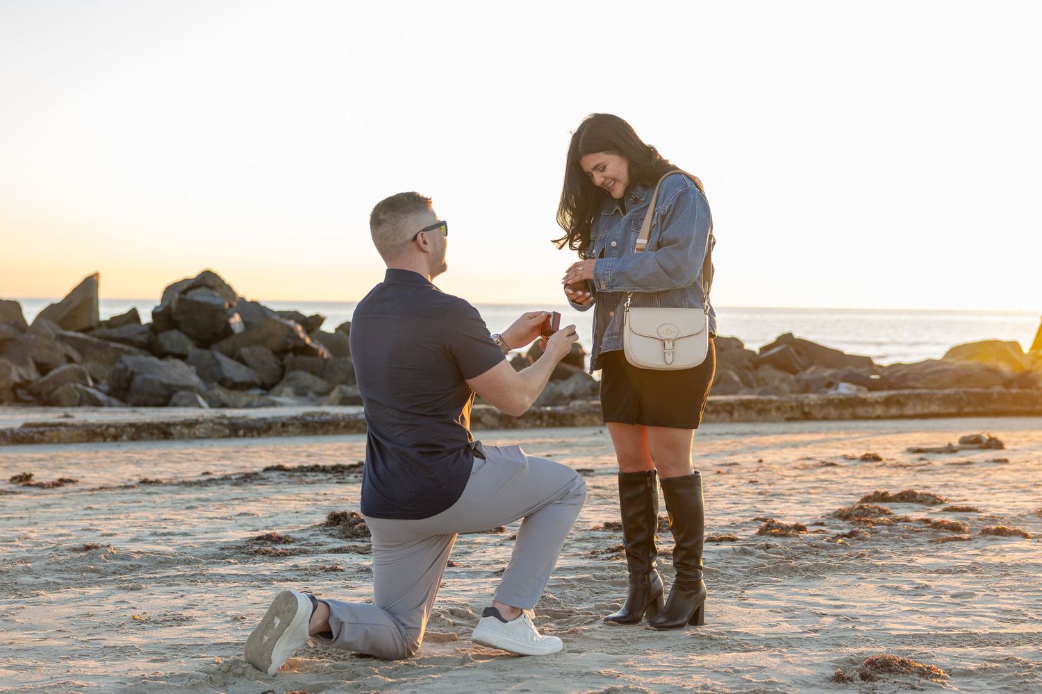 proposal on the beach at sunset