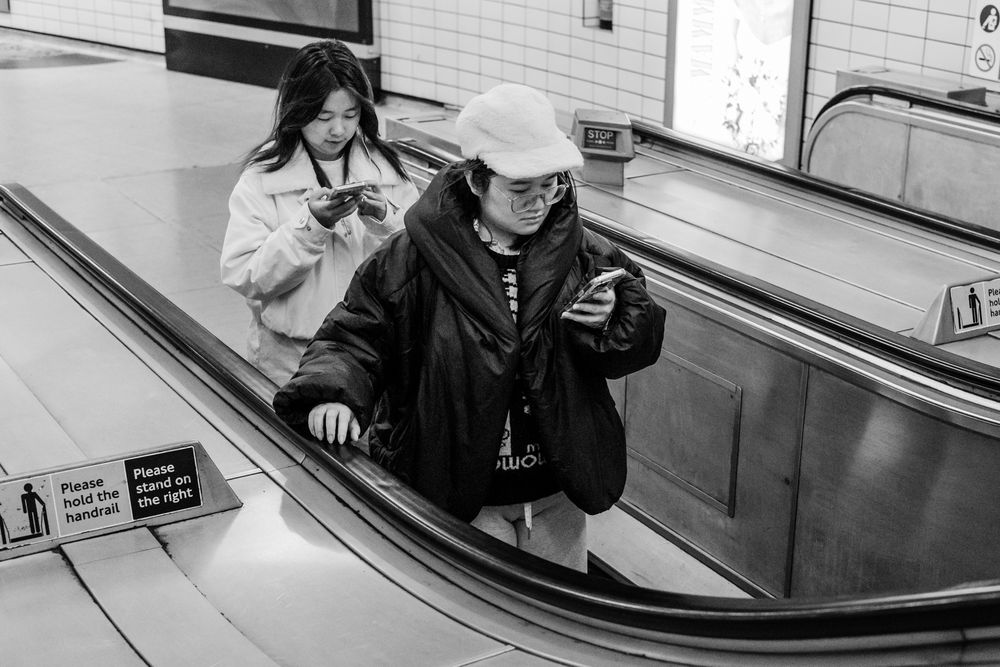 A series of photos showing a person moving down an escalator in a subway or metro station.
