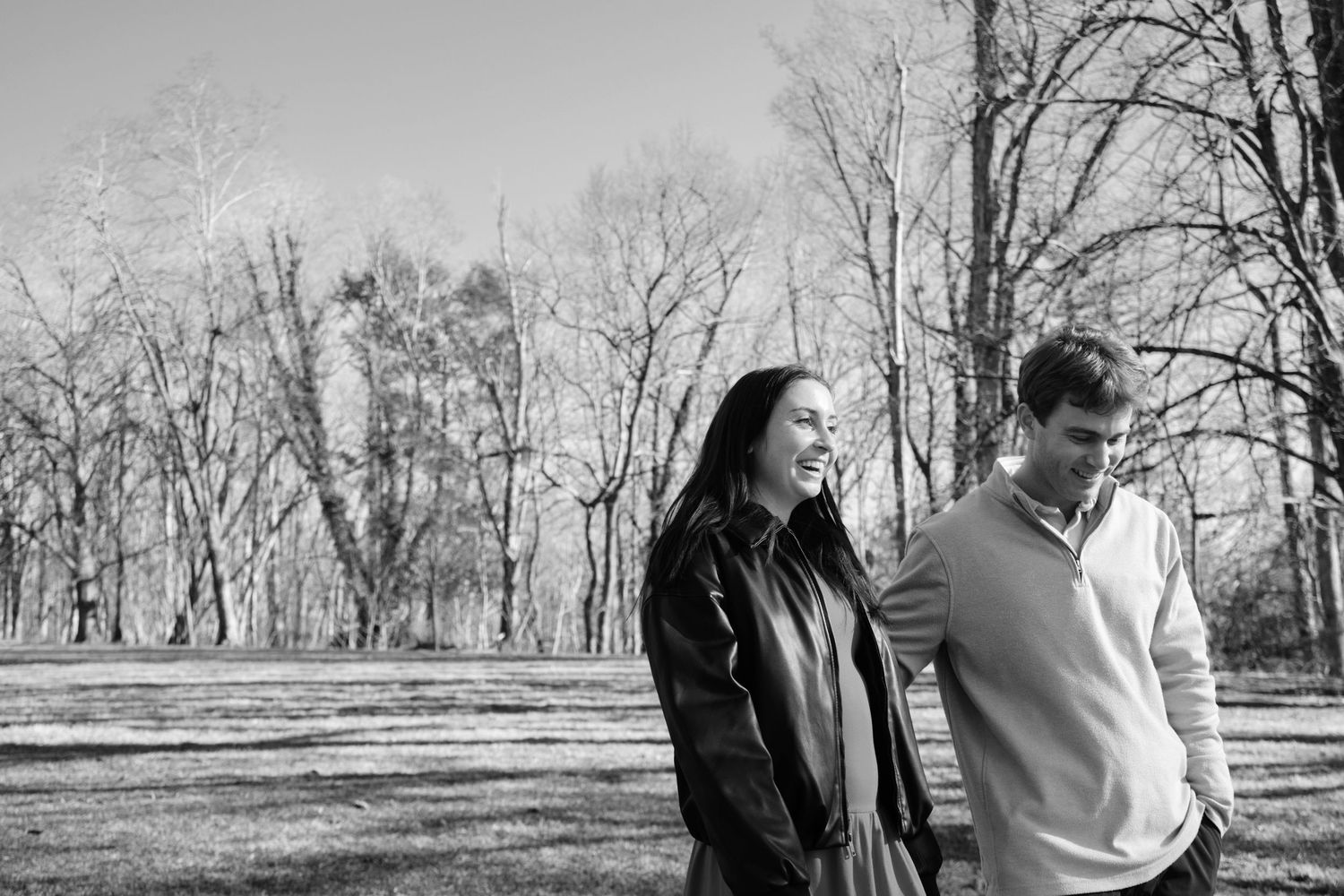 Newly engaged couple walking through the Biltmore Estate grounds in Asheville NC on a warm winter day