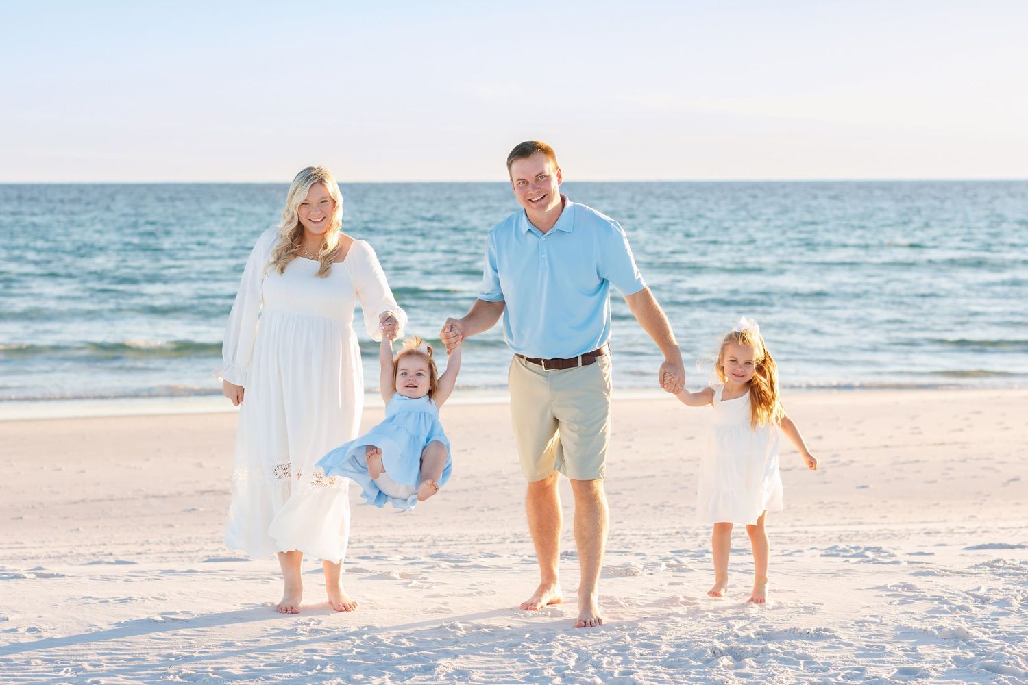 Family walking along the beach during a relaxed photo session in Destin, Florida