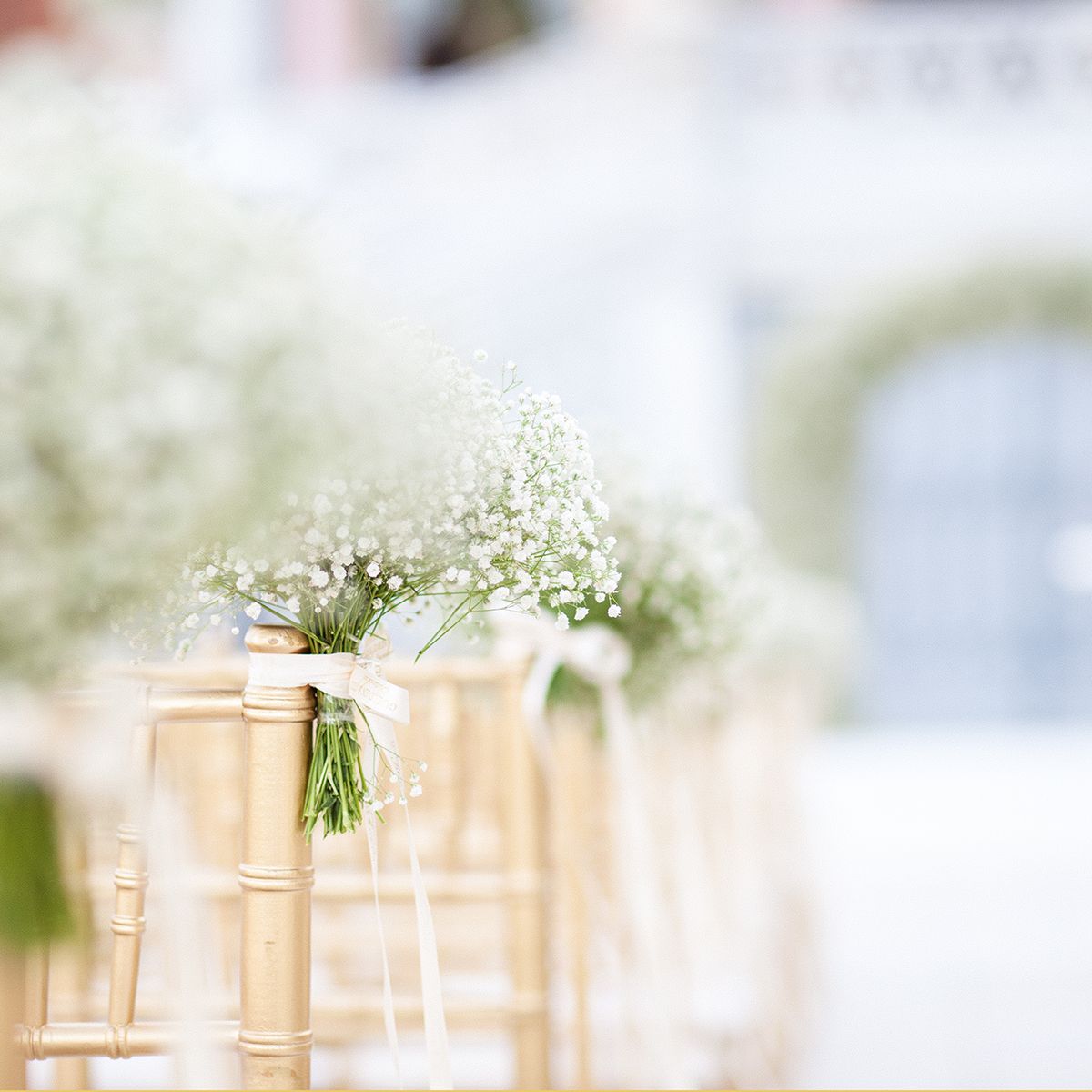Elegant wedding ceremony chair decor with delicate floral arrangement at Ciragan Palace, Istanbul